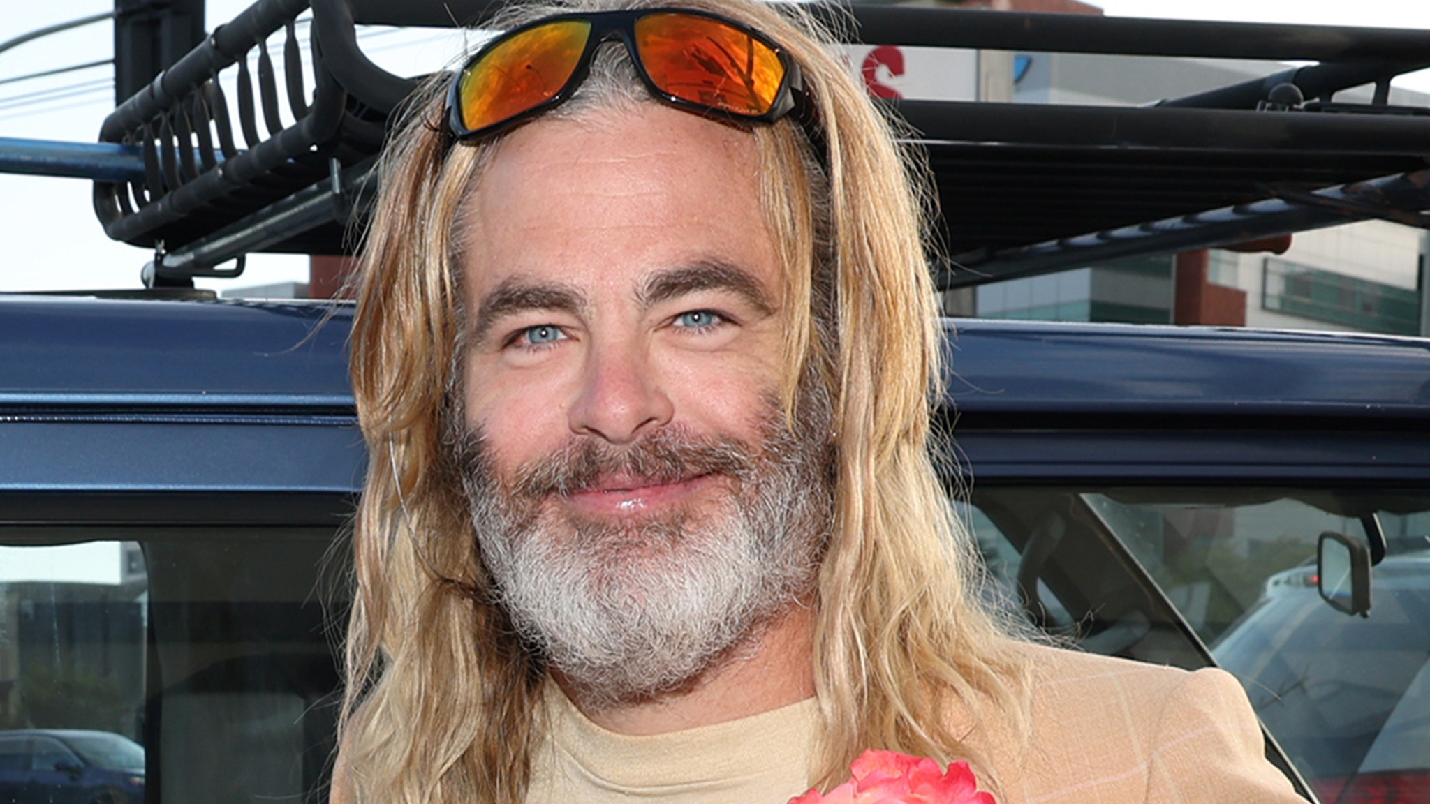 Chris Pine plays 'Poolman' character in Jorts, long blond hair