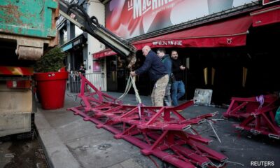 The windmill sails of the Moulin Rouge in Paris collapse