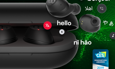 A pair of black translation headphones on a green and black background.