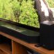 Samsung HW-Q990D soundbar with satellite speakers in front of a TV