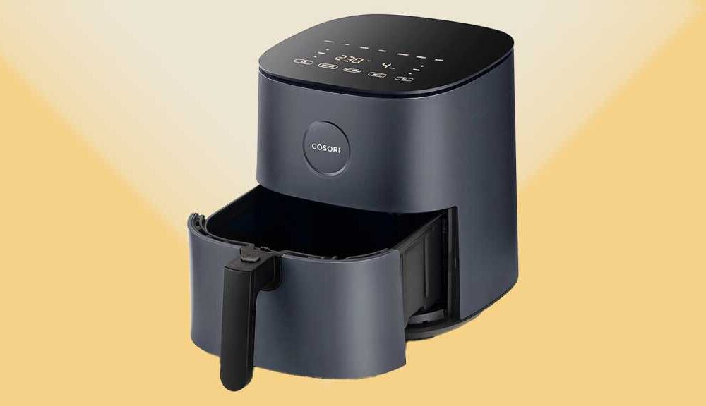 Three-quarter view of a Cosori air fryer on a yellow background