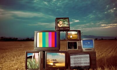 An image of old retro televisions outside with different TV monitors