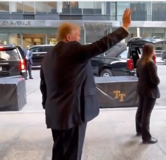 Trump waves to no one.