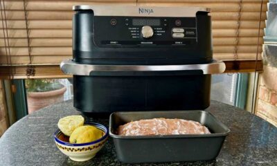 Ninja air fryer with a loaf cake in a tine in front of it