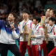 Olympic table tennis medalists from North and South Korea pose for a shared selfie