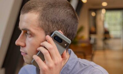 A man holding up a smartphone to his ear